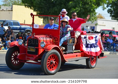 WASCO, CA - SEPTEMBER 6, 2014: This fire engine is no longer in service but is still able to provide some amusement for parade watchers at the annual Festival of Roses.