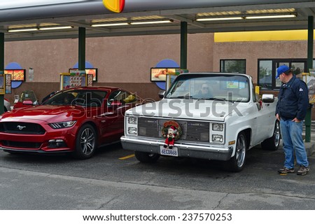 BAKERSFIELD, CA - DECEMBER 13, 2014: Classic cars are lined up at a local drive-in to compete for trophies at the Christmas Joy Ride and Toy Run Car Show.