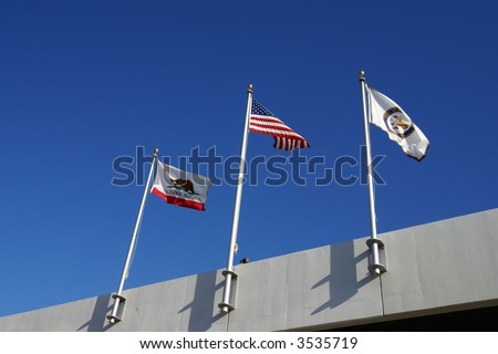 Flags of three governments fly side-by-side, State of California, United States and City of Bakersfield
