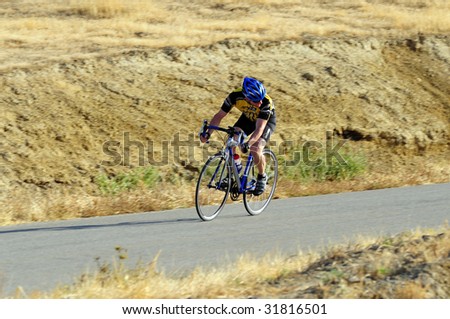 BAKERSFIELD, CA - JUNE 7: Competitor looks back to check peloton, Mens\' 30+ category, Golden Empire Classic professional bicycle road race championships, June 7, 2009, Bakersfield, CA