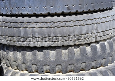 Background or Texture: Stack of old tires exposes worn tread patterns ...