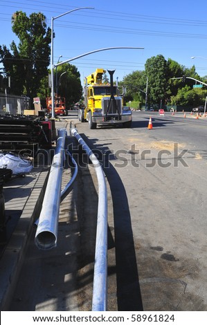 BAKERSFIELD, CA - AUG 12: Electricians completely replace traffic signals, poles and mast arms at a major intersection on August 12, 2010, at Bakersfield, California.