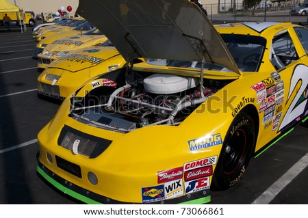 BAKERSFIELD, CA - MAR 12: NASCAR sponsor holds public auction for all their cars and parts on March 12, 2011 in Bakersfield, California. Open hood reveals engine to potential buyers.