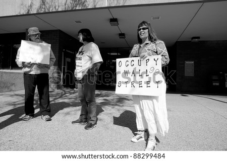 BAKERSFIELD, CA -NOV 5: A scheduled Occupy Wall Street demonstration attracts only four unidentified stalwart people (three are pictured here) in this politically conservative area on November 5, 2011 in Bakersfield, California.