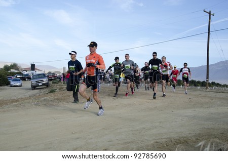 BAKERSFIELD, CA - JAN 14: Contestants run the dirt path cross country leg of the Rio Bravo Rumble biathlon (running and mountain biking) on January 14, 2012, in Bakersfield, California.