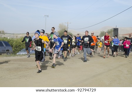 BAKERSFIELD, CA - JAN 14: Men, women and children all run the dirt cross country leg of the Rio Bravo Rumble biathlon (running and mountain biking) on January 14, 2012, in Bakersfield, California.