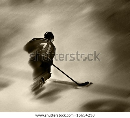 Hockey player is in mid-stride crossing the blueline with the puck in his possession.  Motion blur is added for the effect of speed.  Grunge effect added in Photoshop.
