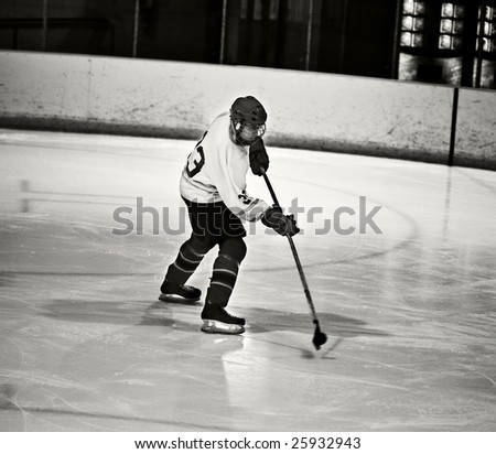 Hockey player taking a shot on net