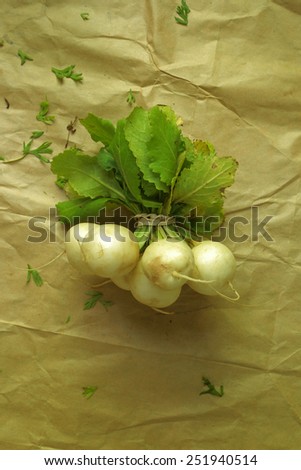 Organic locally grown turnips in a bundle on paper bag background