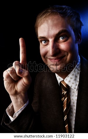 Happy businessman holding up his index finger. Pick Me! or Number One!