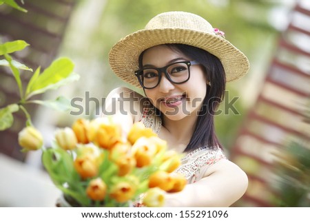 Portraits of girl Happy young woman holding red flowers. Isolated.
