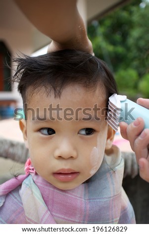 Boy haircut, Asia, Thailand.