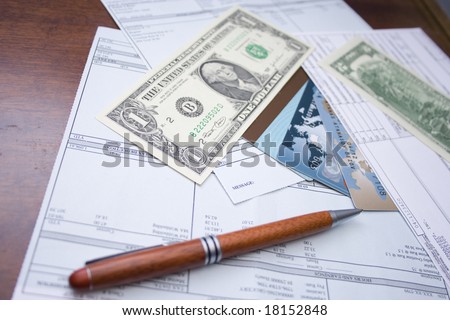 pay checks, pen, credit cards and US dollars