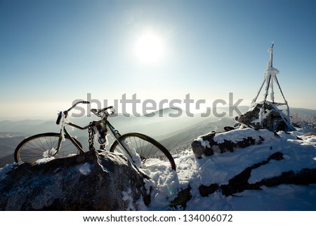 Winter landscape of mountains. old bicycle on a mountain top. Russia, Pidan