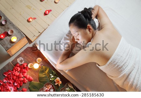 Asian Thai woman in spa salon lying on the massage desk.