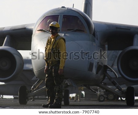 An Aircraft Director Waits in Front of an S-3B Viking for Launch Aboard a Nuclear Aircraft Carrier