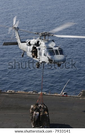 A Navy SH-60 Helicopter Performs Replenishment At Sea On the Nuclear Aircraft Carrier, USS Enterprise