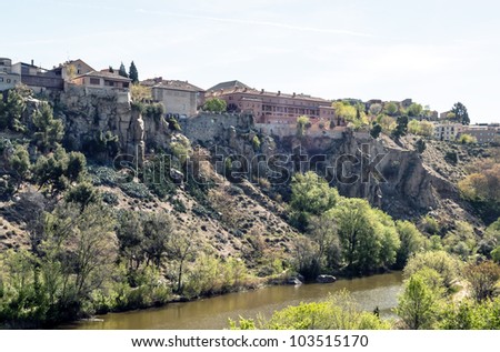 Houses at the top of the slope of the river bank cut in the Spanish city of Toledo