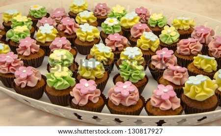 Cupcakes decorated with butter cream and flowers