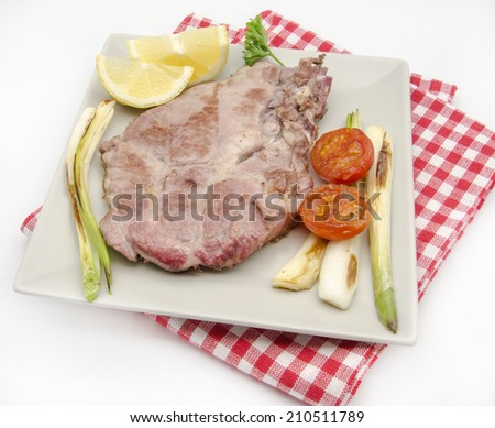 Pork chop with onions and tomatoes