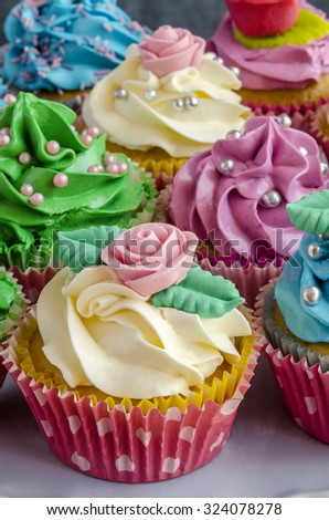 Cupcakes decorated with butter cream in various colors