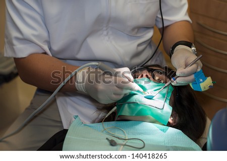 Woman receiving a root canal at the dentist