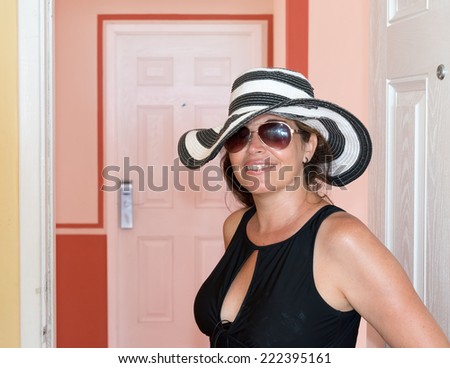 Middle age woman wearing a hat in the tropics during her summer holidays