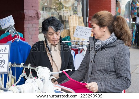 Hispanic woman shopping in Chinese store or shop in Chinatown which is an ethnic enclave in Downtown Toronto with a high concentration of ethnic Chinese residents and businesses.