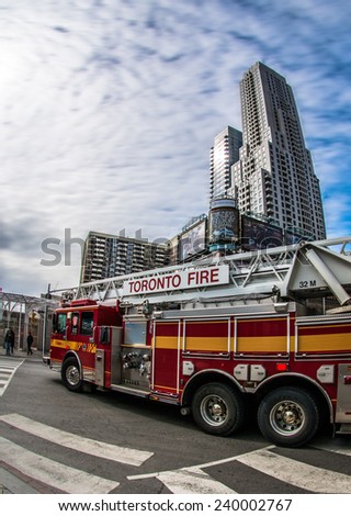 TORONTO,CANADA-JUNE 20,2013: Fire truck rushing to an alarm in the city. Toronto city reports about 300 fire alarms on a daily basis so it is common to see firetrucks and ambulances rushing out.