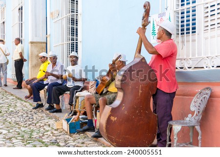 TRINIDAD,CUBA-JULY 22,2014: Cuban traditional music or son street performers in exchange for tourists tips. Trinidad in a UNESCO world heritage site and a major tourist landmark in Cuba