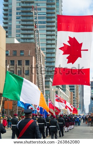 TORONTO,CANADA-MARCH 15,2015:Irish flag along with Canadian flag during the St. Patrick\'s Day Parade 28th edition which is the fourth largest celebration of its kind in the world.