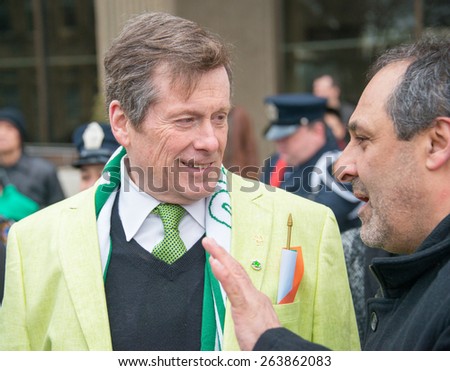 TORONTO,CANADA-MARCH 15,2015:Toronto Mayor John Tory chat with a city citizen during the 28th edition of St. Patrick\'s Day Parade, the fourth largest in the world