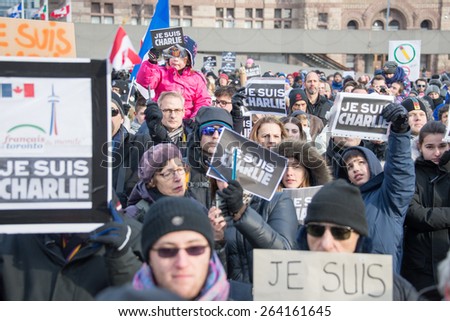 TORONTO,CANADA-JANUARY 11,2015:People meet  in the Je Suis Charlie vigil at Nathan Phillips Square to honor the victims of the Charlie Hebdo magazine shootings and to demonstrate against the terrorism
