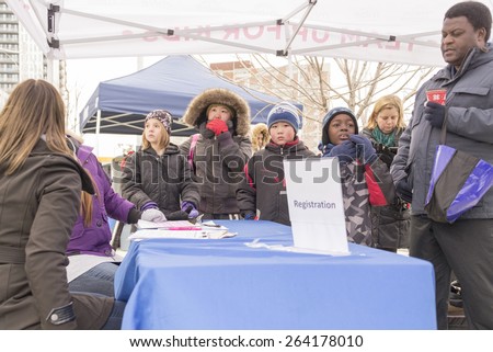 TORONTO,CANADA-JANUARY 3,2015:Children registration booth in Regent Park ice rink. Registered children could participate in the official opening of the rink and had time with Toronto Police Officers