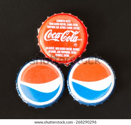 TORONTO,CANADA-APRIL 4,2015: Bottle caps of carbonated softdrinks. Stock price of carbonated drinks have been affected by health concerns attached to such sugary or quimically sweetened snacks.