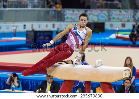 TORONTO,CANADA-JULY 11,2015:Samuel Mikulak in the pommel horse during the gymnastic artistic competition of the Toronto 2015 PanAm games. United States team won gold medal.CRED IN REVIEW