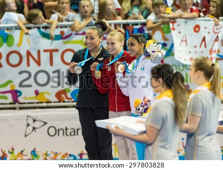 TORONTO,CANADA-JULY 11,2015:Toronto Panam Games 2015:Medal ceremony Women Floor Final in Gymnastic Artistic. Gold Ellie Black wins gold, Amelia Hudley wins silver and Ana Gomez wins Bronze 01953074