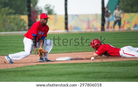 TORONTO,CANADA-JULY 12,2015: Toronto Pan American Games 2015, Baseball tournament: Canada team vs Colombia, a North American player steals the second base with enough time to get safe  01953074