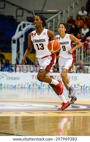 TORONTO,CANADA-JULY 16,2015: Toronto 2015 Pan Am or Pan American Games, women basketball: Tamara Tathan (13) from team Canada on the attack moving swiftly towards opponent territory.CN 01953074