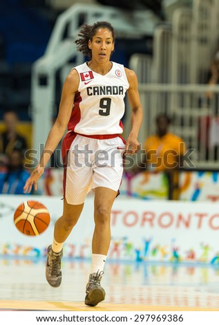 TORONTO,CANADA-JULY 16,2015: Toronto 2015 Pan Am or Pan American Games, women basketball: Miranda Ayin (9) from team Canada, attacks opponent court on the left flank.CN 01953074