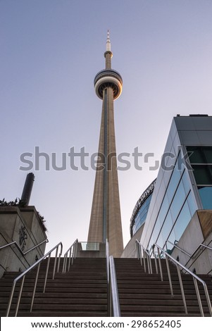 TORONTO,CANADA-JUNE 21,2015:Stairs leading up to the CN Tower.  The gray stone tower rises over several other buildings during the day, photographed from below.