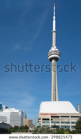 TORONTO,CANADA-JUNE 15,2015: Rogers Centre sports stadium with the CN Tower against blue sky. Rogers Centre is a multi-purpose stadium situated just southwest of the CN Tower.