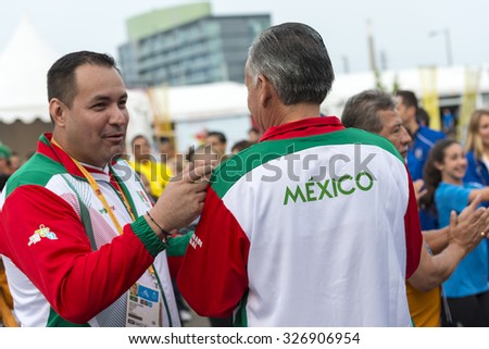 TORONTO,CANADA-JULY 8,2015: Mexican officials in conversation with each other at the 2015 Pan Am Games.