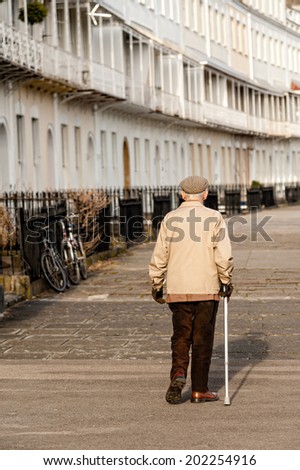 Bristol, England - February 28, 2013: Elderly man walking on Royal York Crescent a major residential street in the Clifton area of Bristol on February 28, 2013 in Bristol.