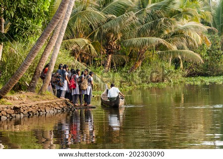 ALAPPUZHA, INDIA - January 21, 2014: A group of teenage school children boarding a boat to travel home from school on January 21, 2014 in Alappuzha, Kerela, India.