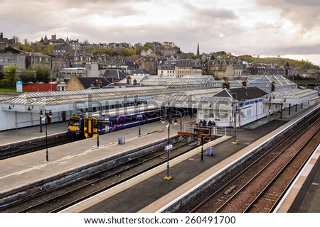 STIRLING, SCOTLAND - APRIL 09: Trains stopped at Stirling railway with Stirling Castle in distance on 09 April, 2012 in Stirling, Scotland.
