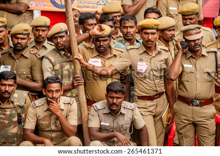 ALANGANALLUR, INDIA-JAN 16: Police officers watching the bull taming sport of jallikattu on January 16, 2014 in Alanganallur, Tamil Nadu, India.  Jallikattu was banned in 2015 by Supreme Court.