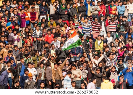 WAGAH, INDIA, JANUARY - 26, 2015: Crowd of Indian people celebrating at India-Pakistan Wagah border flag ceremony during the India Republic Day on January, 26 2015 in Wagah, India.