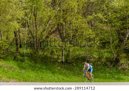 LA BRESSE, FRANCE - MAY 18, 2013: A man on a road racing bicycle in training on a steep road in the Vosges mountains.