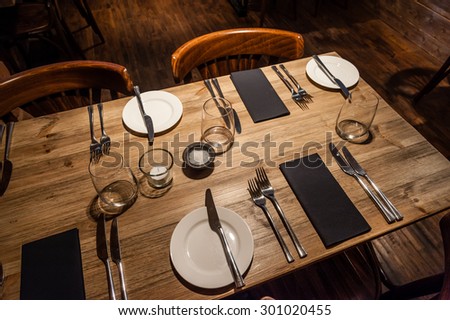 A rustic restaurant table set for service.